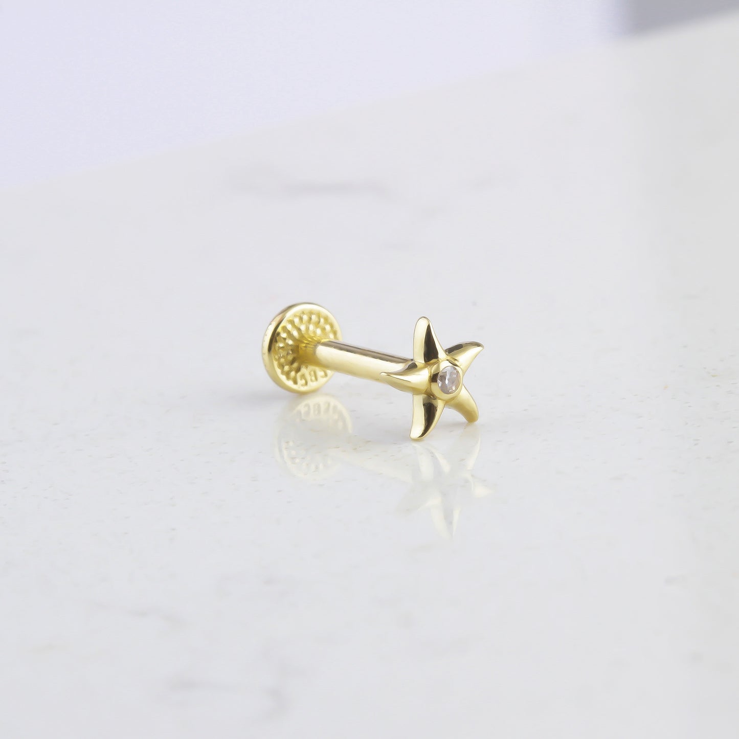 STARFISH TRAGUS PIERCING